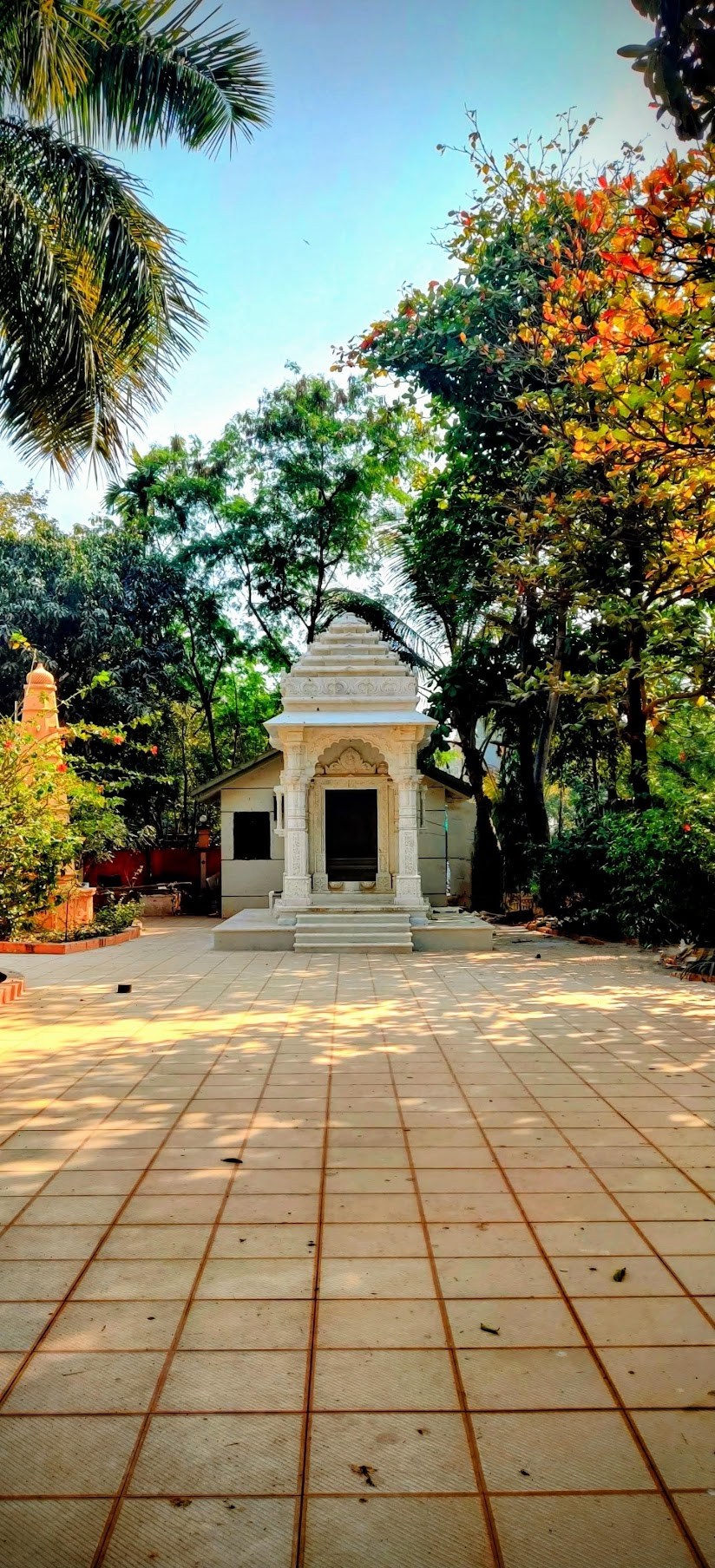 A small white shrine surrounded by trees